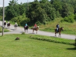 Guests riding horses in front of Alluring View